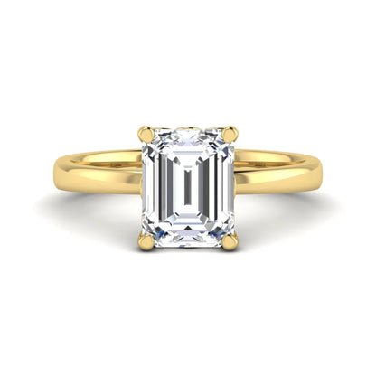 Emerald cut lab grown diamond solitaire engagement ring featuring a 2.62 carat IGI certified center diamond in yellow gold.