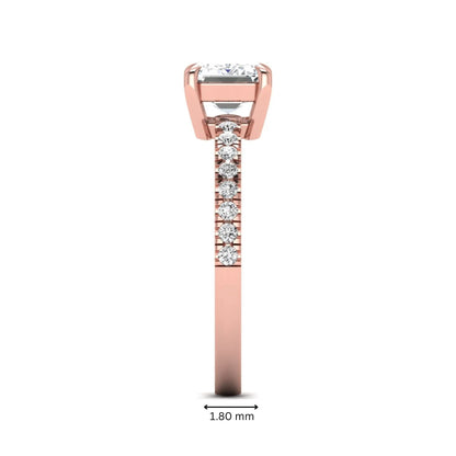 Emerald cut lab grown diamond solitaire pavé engagement ring with four-prong setting and rose gold tone band.