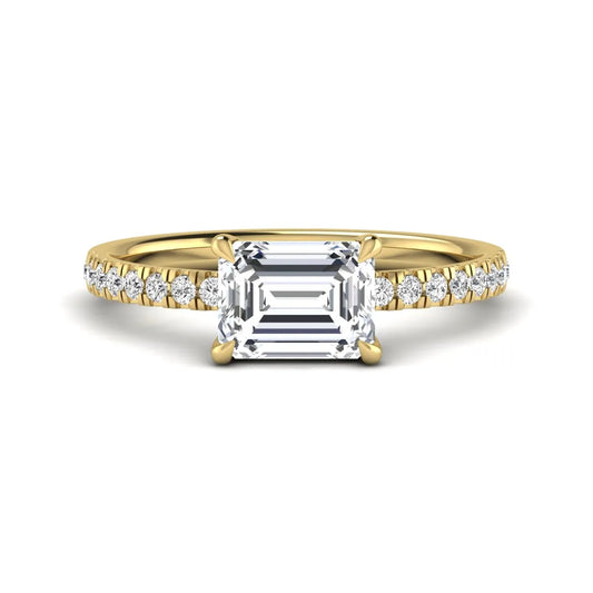 Emerald cut lab grown diamond solitaire pavé engagement ring with four-prong setting and yellow gold tone band.