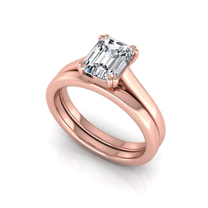 Emerald cut lab grown diamond solitaire ring set featuring a 1.74 carat IGI certified center diamond in a four-prong setting with a matching plain wedding band in a rose gold design.