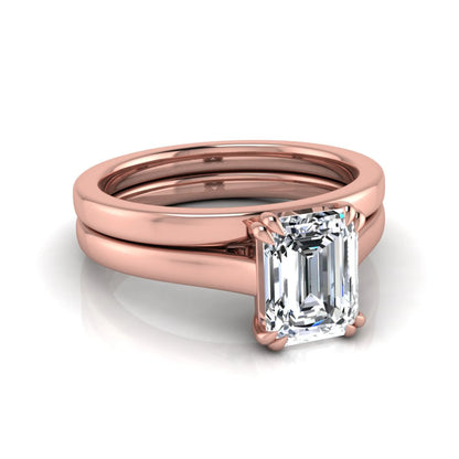 Emerald cut lab grown diamond solitaire ring set featuring a 1.74 carat IGI certified center diamond in a four-prong setting with a matching plain wedding band in a rose gold design.