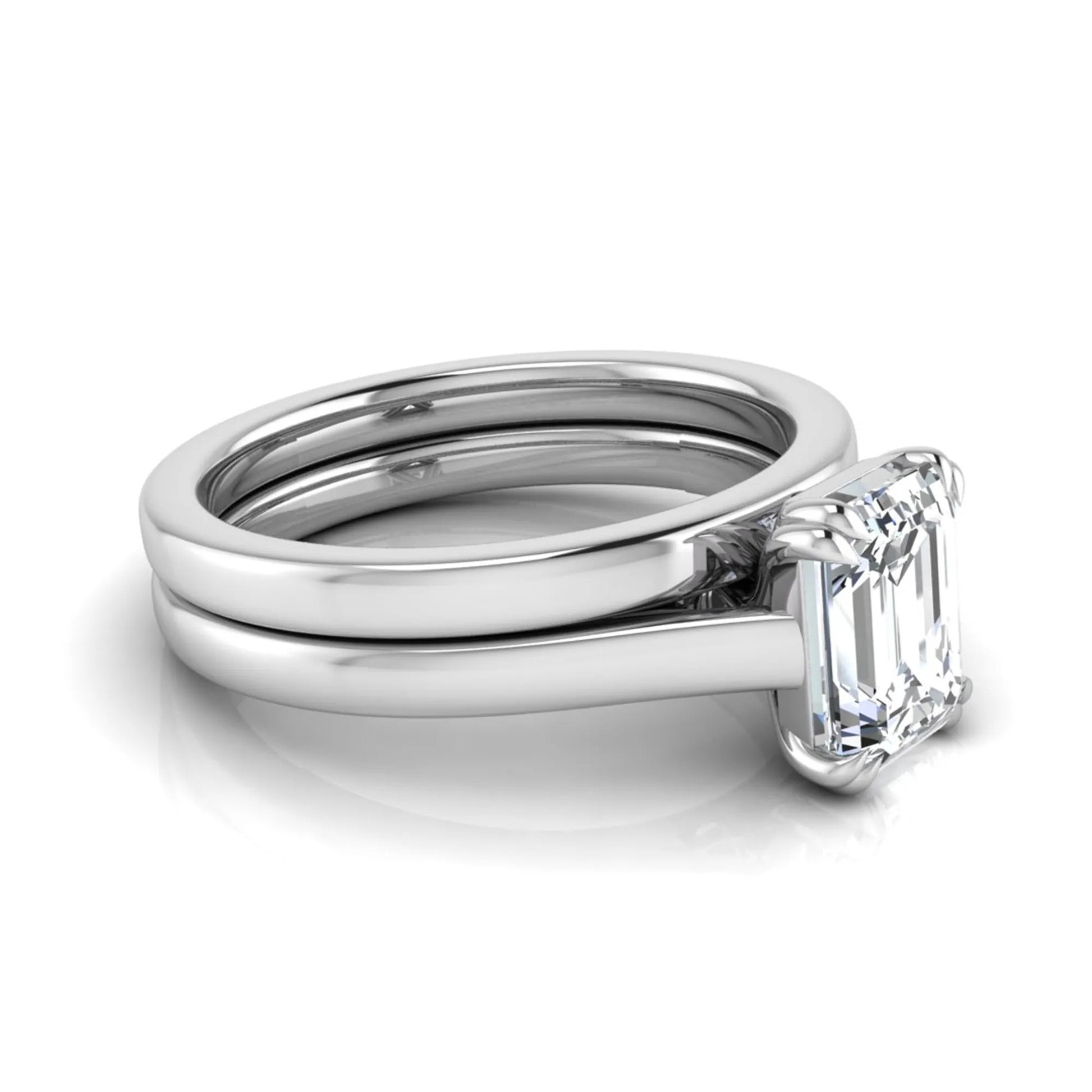 Emerald cut lab grown diamond solitaire ring set featuring a 1.74 carat IGI certified center diamond in a four-prong setting with a matching plain wedding band in a white gold design.