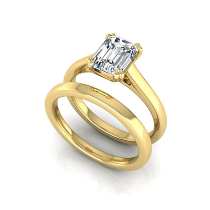 Emerald cut lab grown diamond solitaire ring set featuring a 1.74 carat IGI certified center diamond in a four-prong setting with a matching plain wedding band in a yellow gold design.