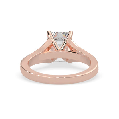 Rose gold ring with a diamond on a white background