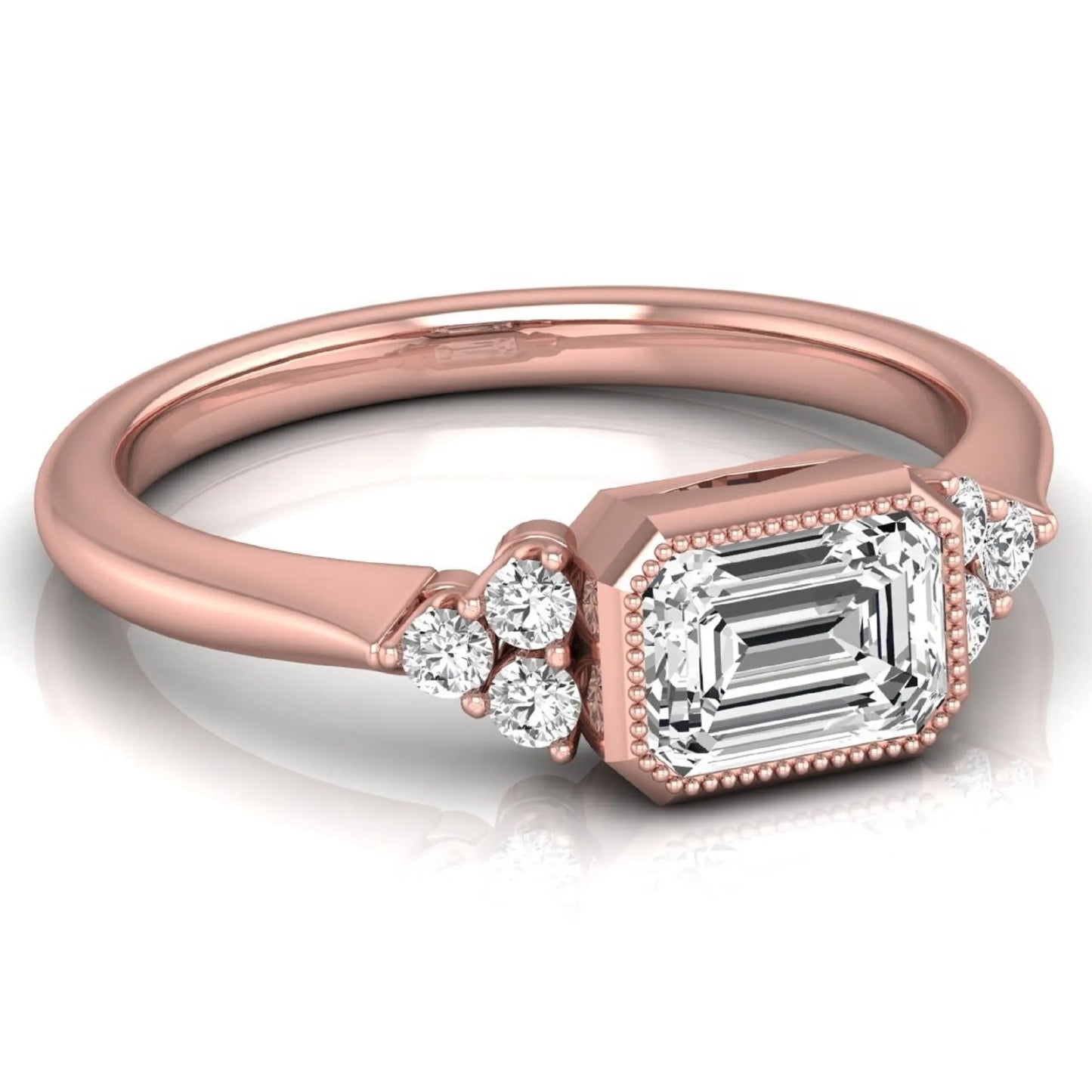 Emerald cut lab grown diamond engagement ring featuring a milgrain bezel setting with round side stone clusters in rose gold.