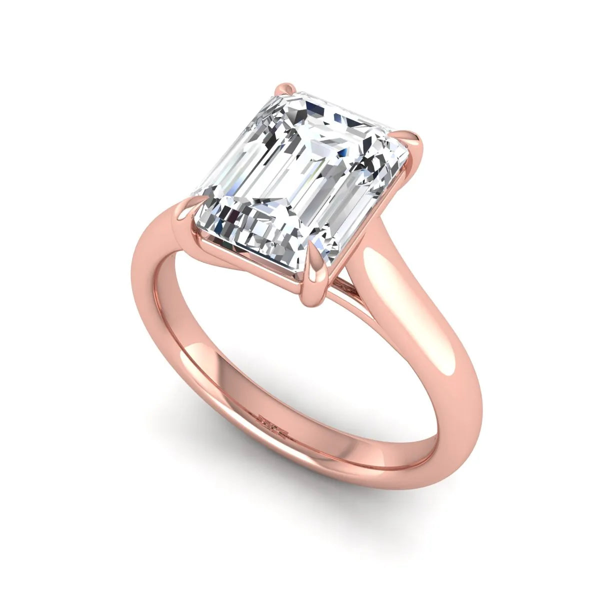 Emerald cut lab grown diamond solitaire engagement ring with a four-prong setting and polished tapered rose gold band.