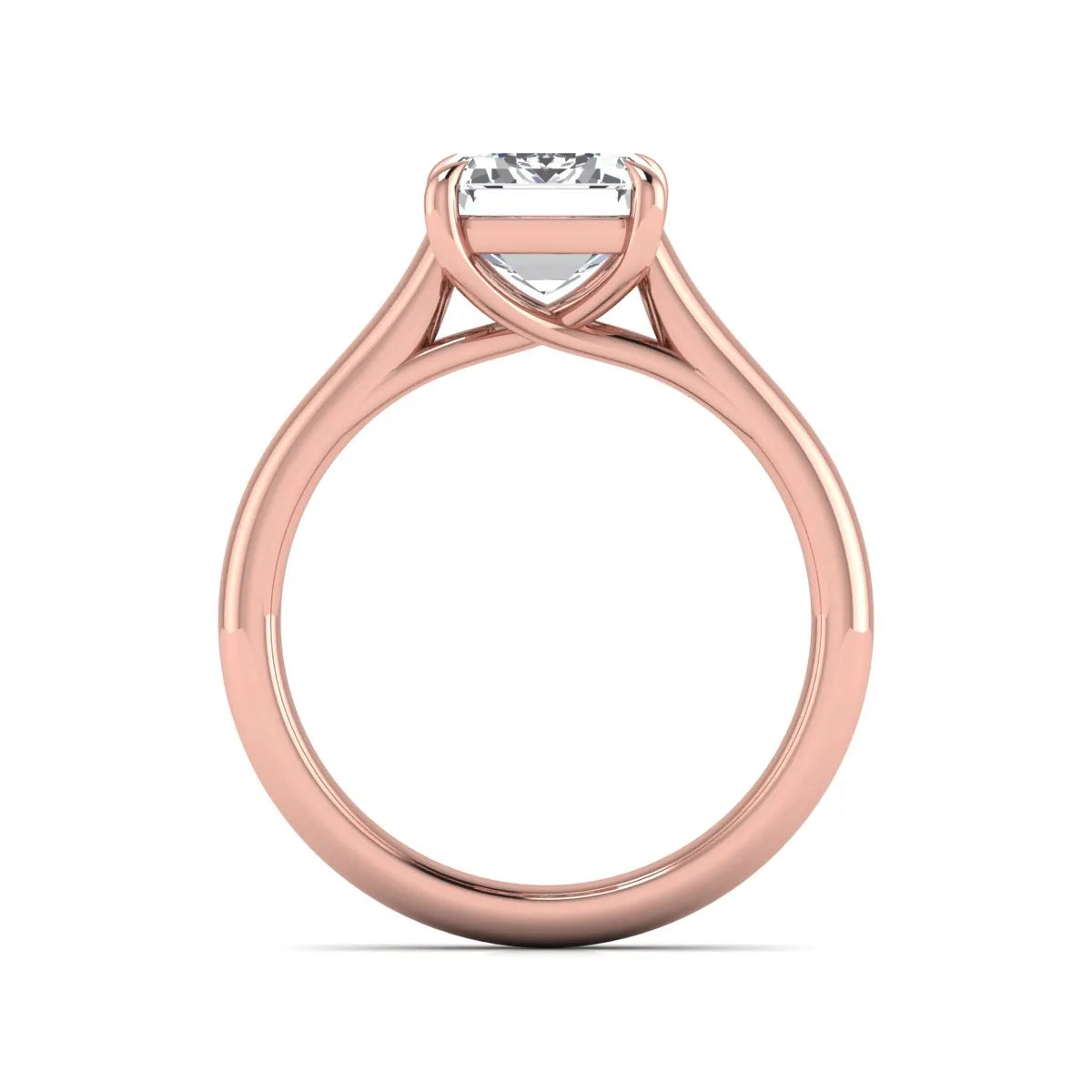 Emerald cut lab grown diamond solitaire engagement ring with a four-prong setting and polished tapered rose gold band.