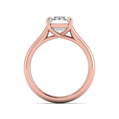 Emerald cut lab grown diamond solitaire engagement ring with a four-prong setting and polished tapered rose gold band.