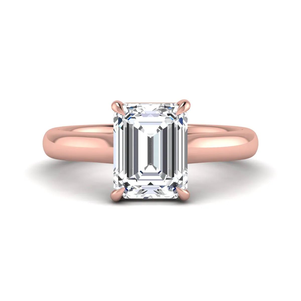 Emerald cut lab grown diamond solitaire engagement ring with a four-prong setting and polished tapered rose gold band.