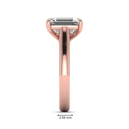 Emerald cut lab grown diamond solitaire engagement ring with a four-prong setting and polished tapered rose gold band.