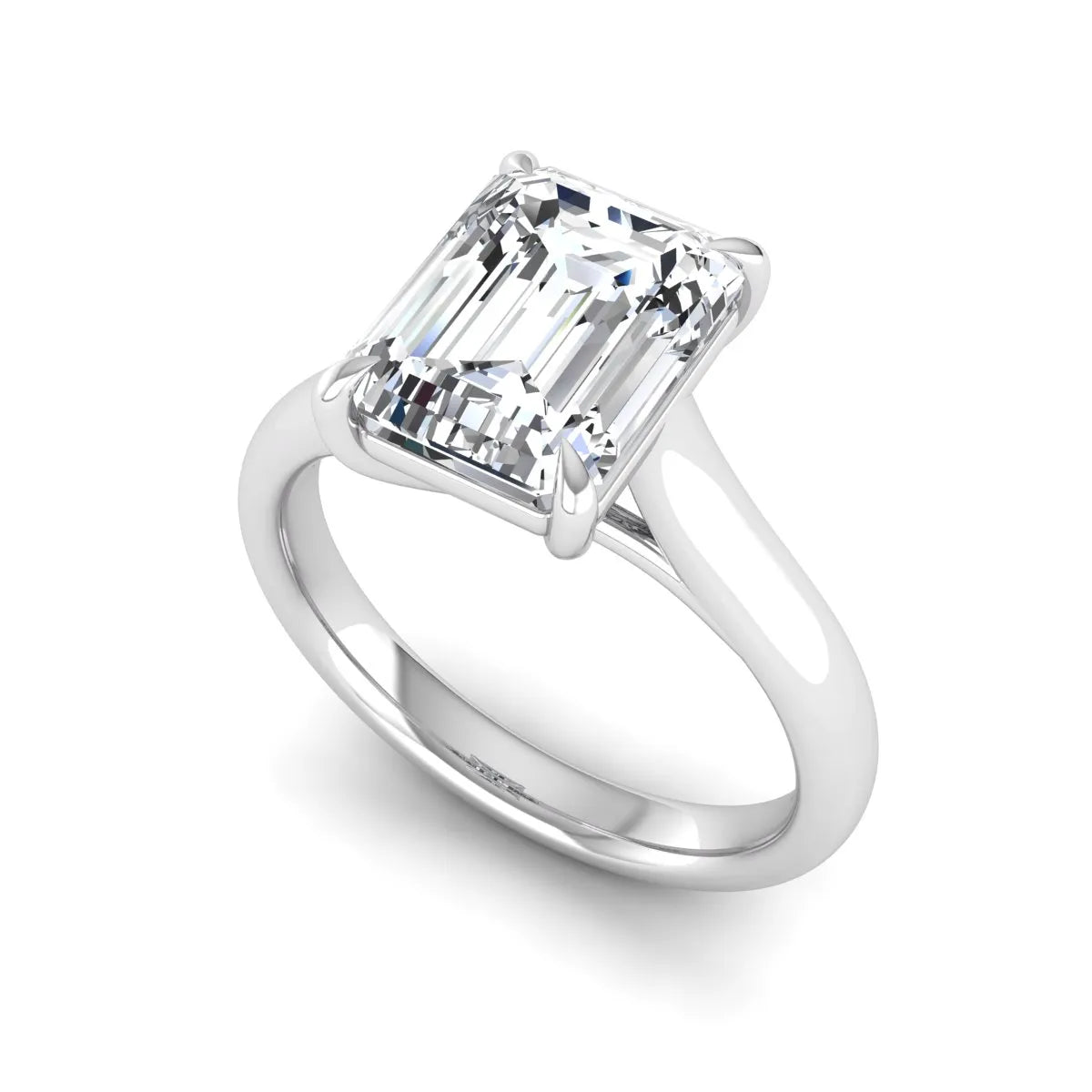 Emerald cut lab grown diamond solitaire engagement ring with a four-prong setting and polished tapered white gold band.