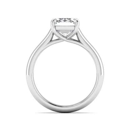 Emerald cut lab grown diamond solitaire engagement ring with a four-prong setting and polished tapered white gold band.