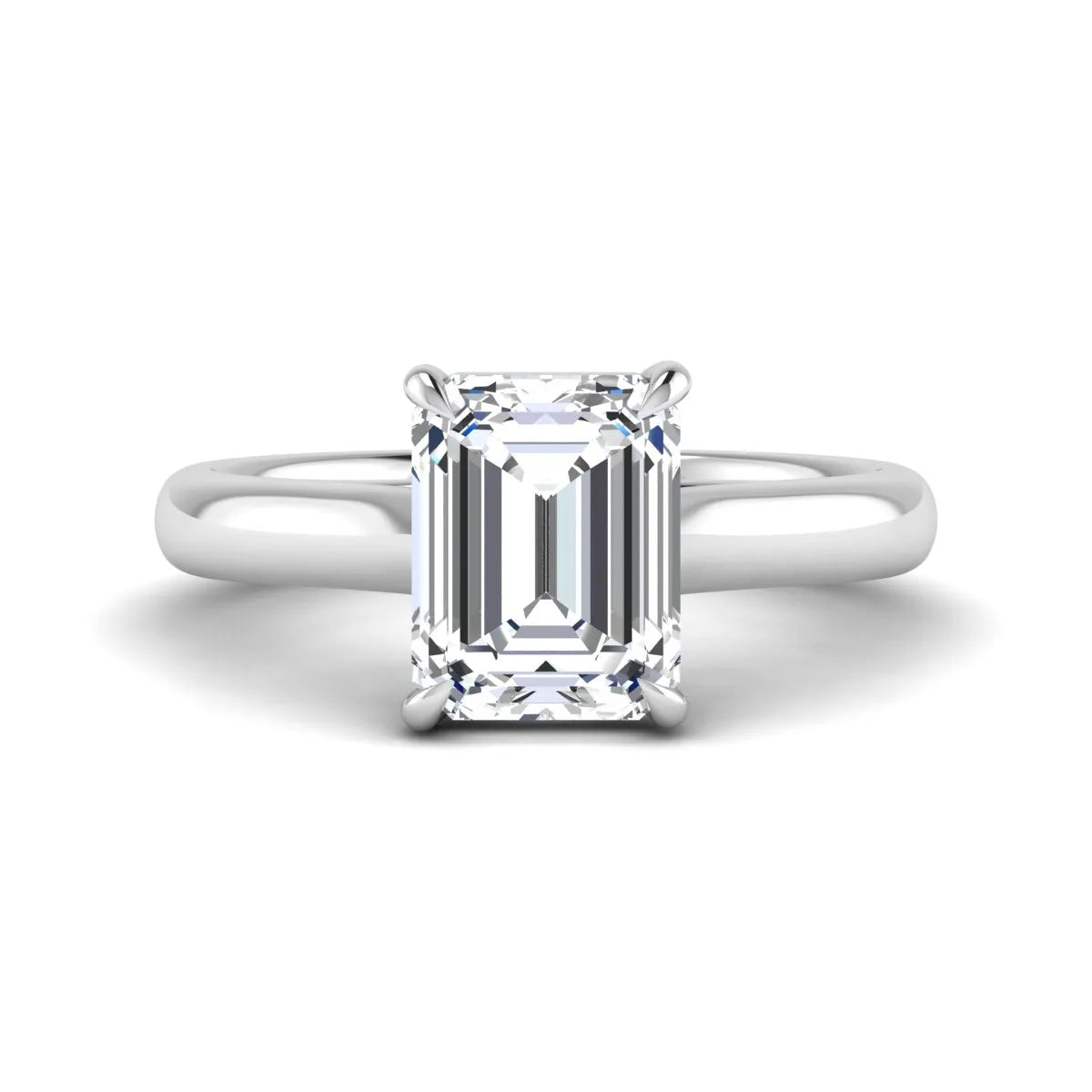 Emerald cut lab grown diamond solitaire engagement ring with a four-prong setting and polished tapered white gold band.
