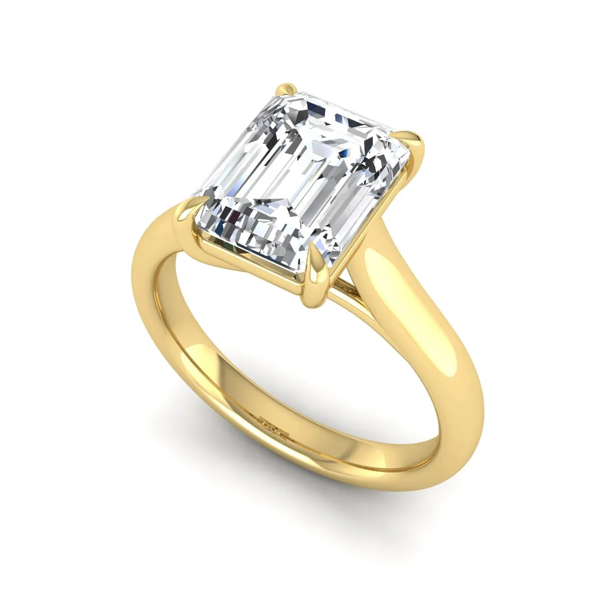 Emerald cut lab grown diamond solitaire engagement ring with a four-prong setting and polished tapered yellow gold band.