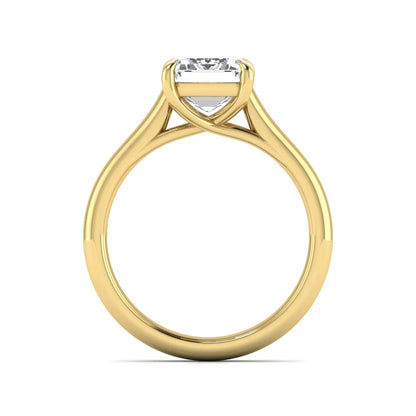 Emerald cut lab grown diamond solitaire engagement ring with a four-prong setting and polished tapered yellow gold band.