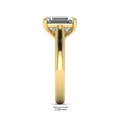 Emerald cut lab grown diamond solitaire engagement ring with a four-prong setting and polished tapered yellow gold band.