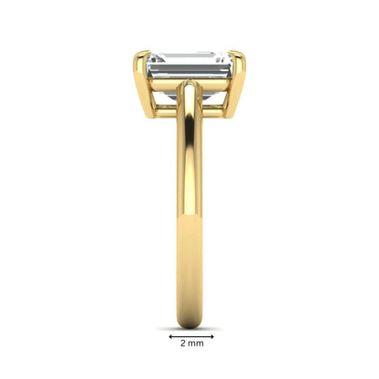 Emerald Cut Solitaire Lab Grown Diamond Engagement Ring featuring a 9.05 × 6.62 mm IGI Certified emerald-cut diamond in a four-prong cathedral setting with a polished yellow gold band.