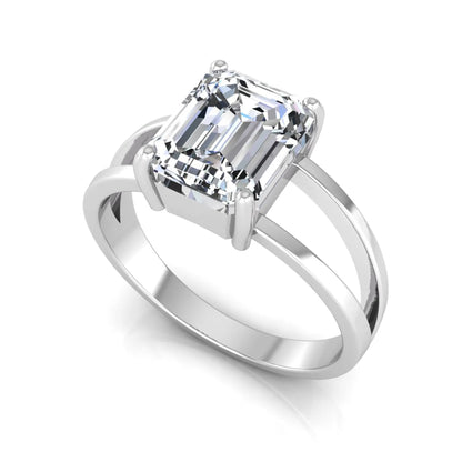 Emerald cut lab grown diamond split shank engagement ring featuring a classic four-prong setting and polished white gold style band.