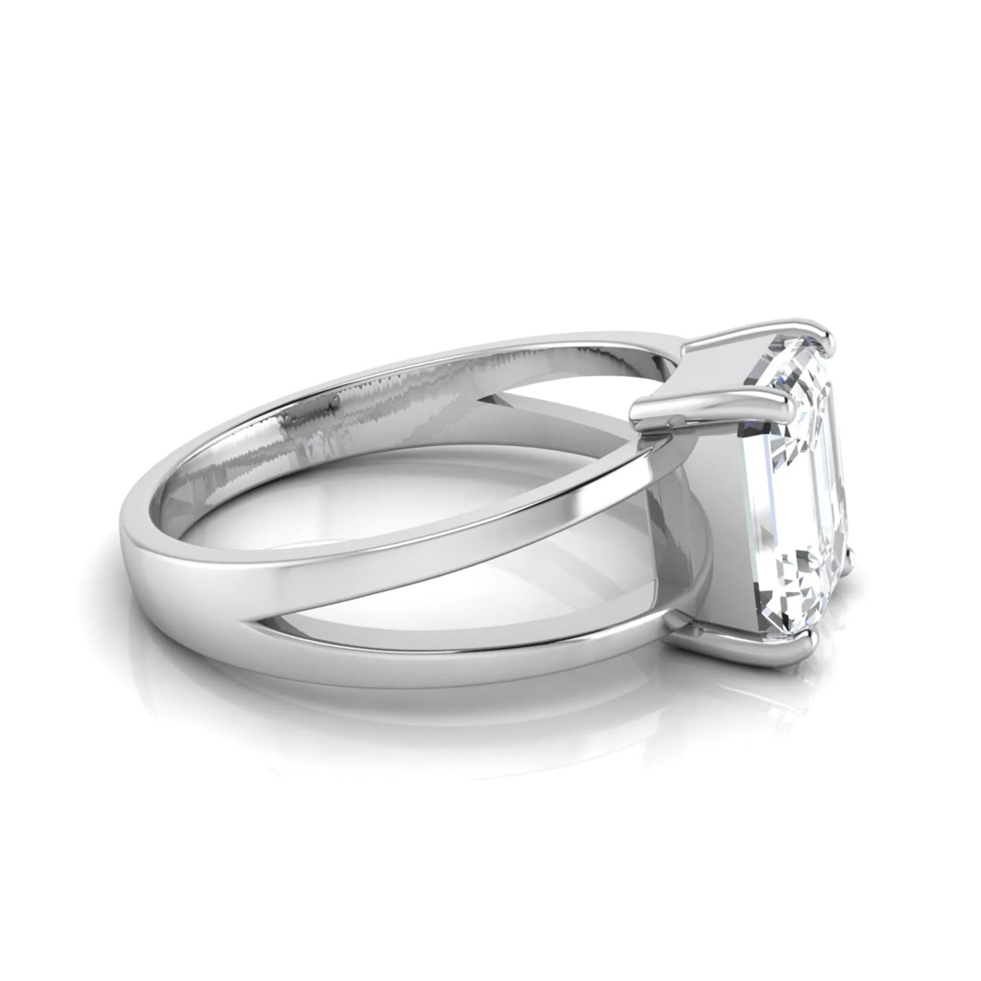 Emerald cut lab grown diamond split shank engagement ring featuring a classic four-prong setting and polished white gold style band.