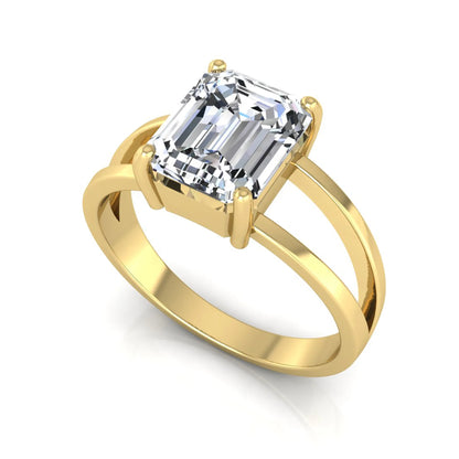 Emerald cut lab grown diamond split shank engagement ring featuring a classic four-prong setting and polished yellow gold style band.