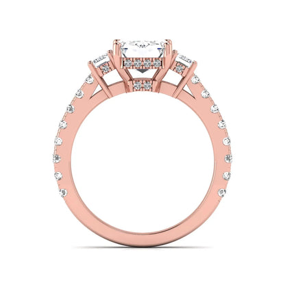 Emerald cut three stone lab grown diamond engagement ring in rose gold featuring a 2.62 carat IGI certified center diamond with emerald cut side stones and pavé band.