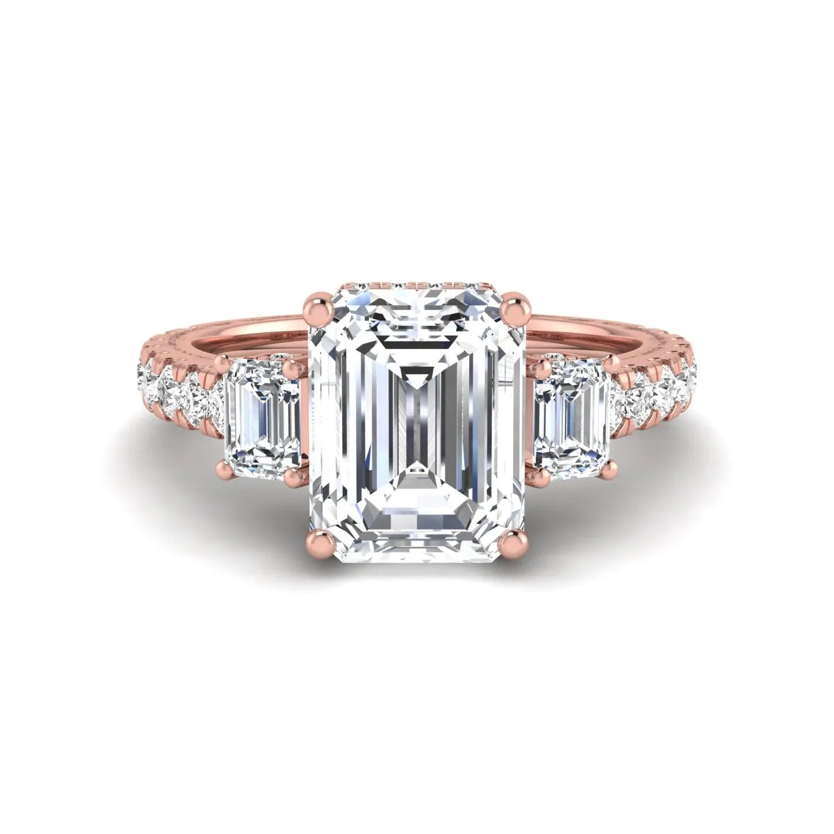 Emerald cut three stone lab grown diamond engagement ring in rose gold featuring a 2.62 carat IGI certified center diamond with emerald cut side stones and pavé band.