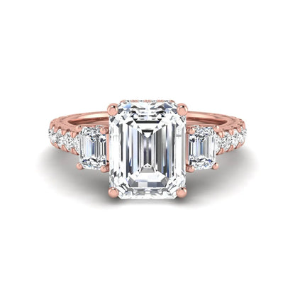 Emerald cut three stone lab grown diamond engagement ring in rose gold featuring a 2.62 carat IGI certified center diamond with emerald cut side stones and pavé band.