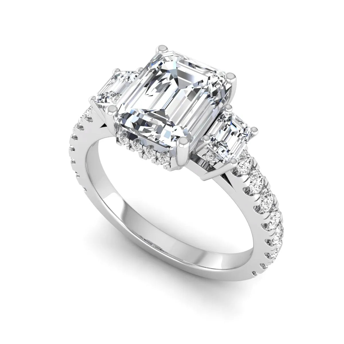 Emerald cut three stone lab grown diamond engagement ring in white gold featuring a 2.62 carat IGI certified center diamond with emerald cut side stones and pavé band.