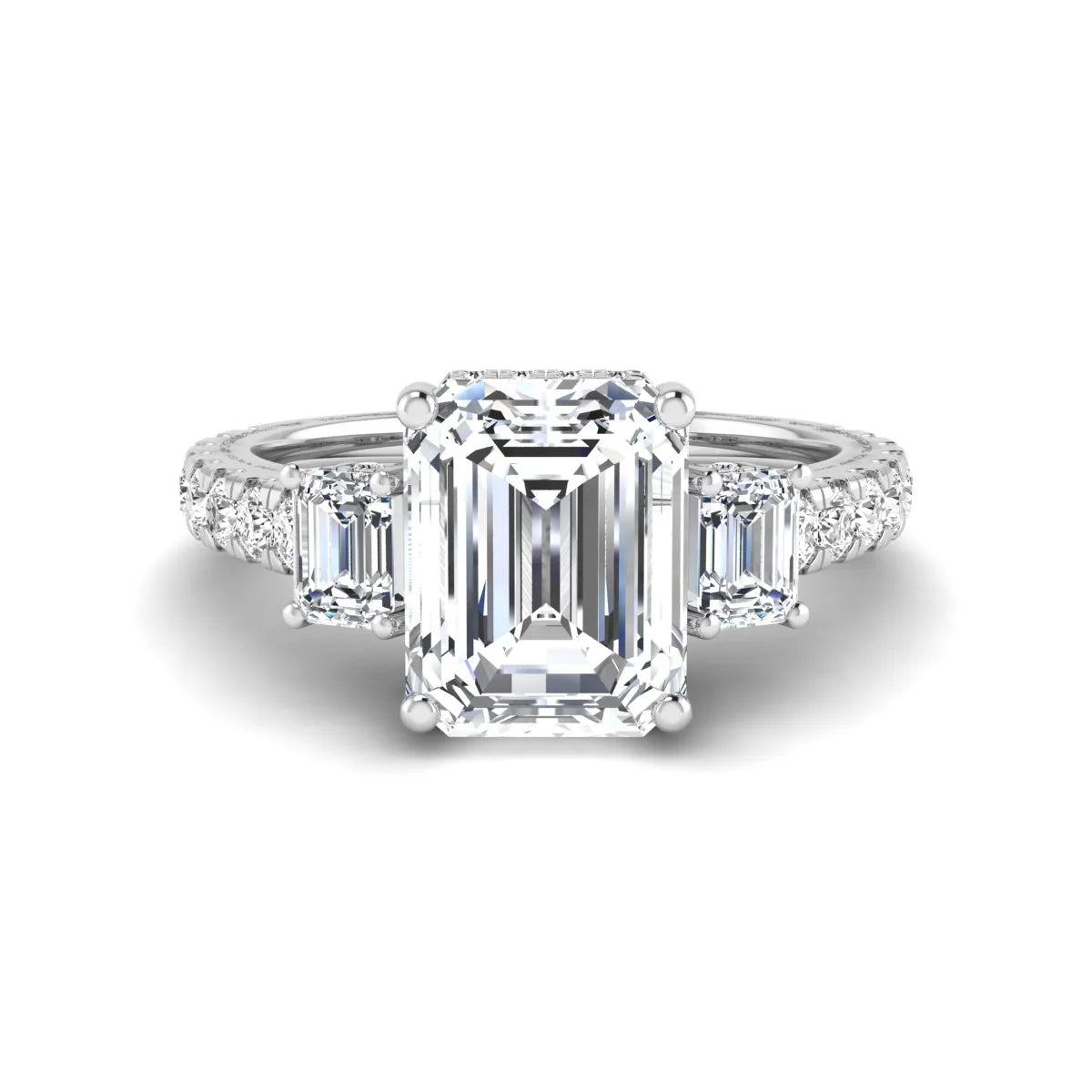 Emerald cut three stone lab grown diamond engagement ring in white gold featuring a 2.62 carat IGI certified center diamond with emerald cut side stones and pavé band.