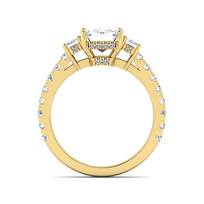 Emerald cut three stone lab grown diamond engagement ring in yellow gold featuring a 2.62 carat IGI certified center diamond with emerald cut side stones and pavé band.