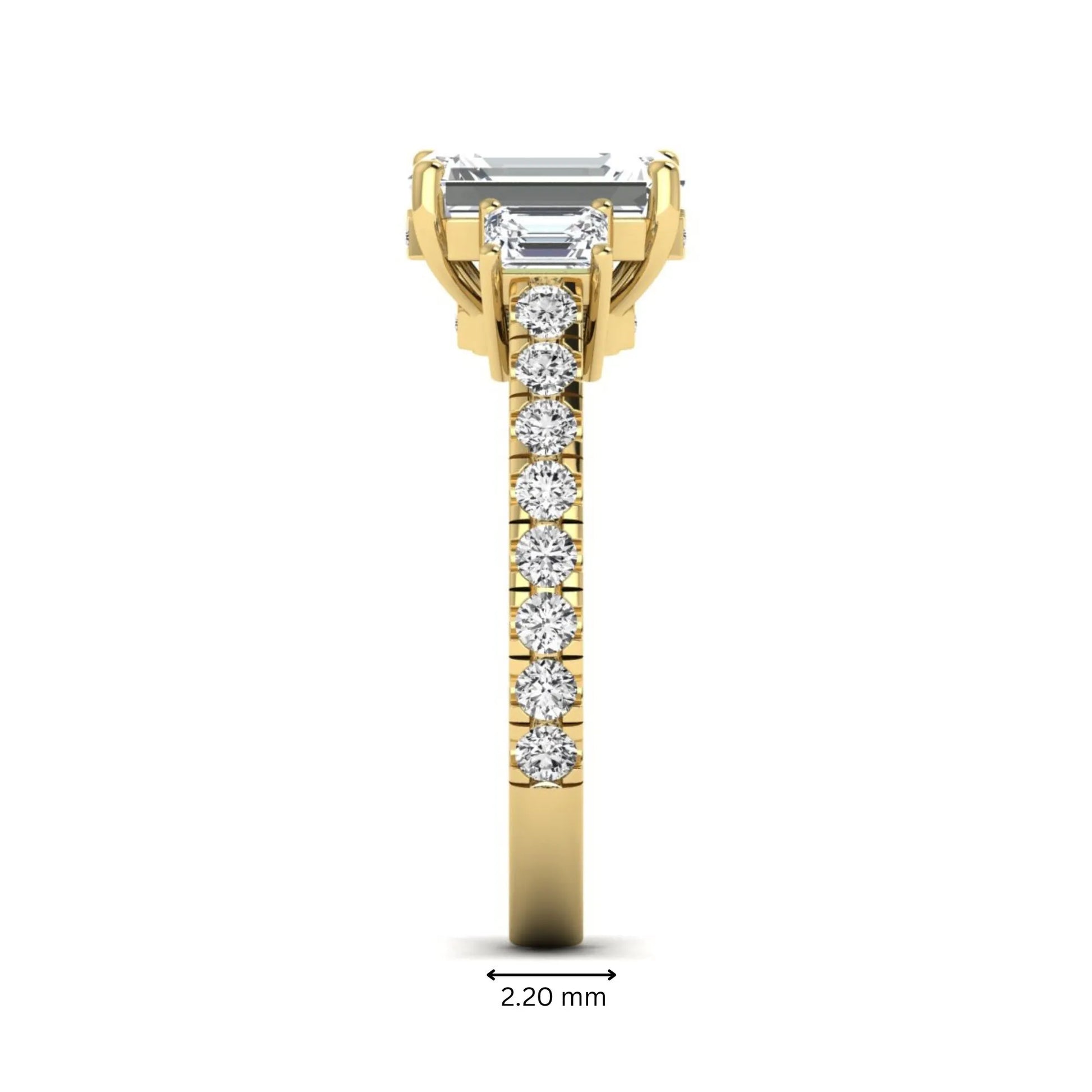 Emerald cut three stone lab grown diamond engagement ring in yellow gold featuring a 2.62 carat IGI certified center diamond with emerald cut side stones and pavé band.