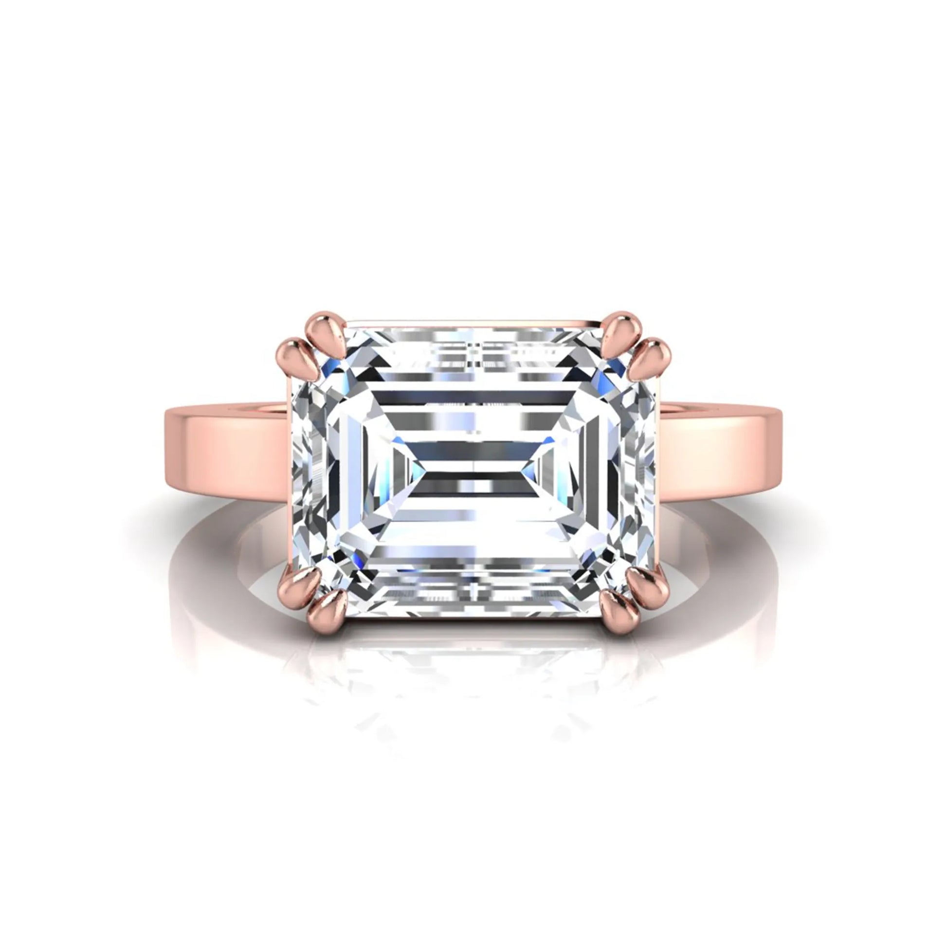 Emerald cut lab grown diamond solitaire engagement ring featuring a 3.79 carat IGI certified center diamond in a double claw prong setting with a rose gold band.