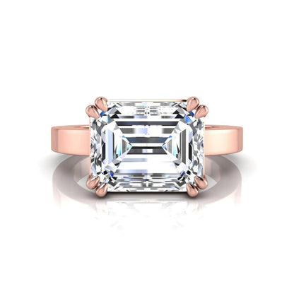 Emerald cut lab grown diamond solitaire engagement ring featuring a 3.79 carat IGI certified center diamond in a double claw prong setting with a rose gold band.