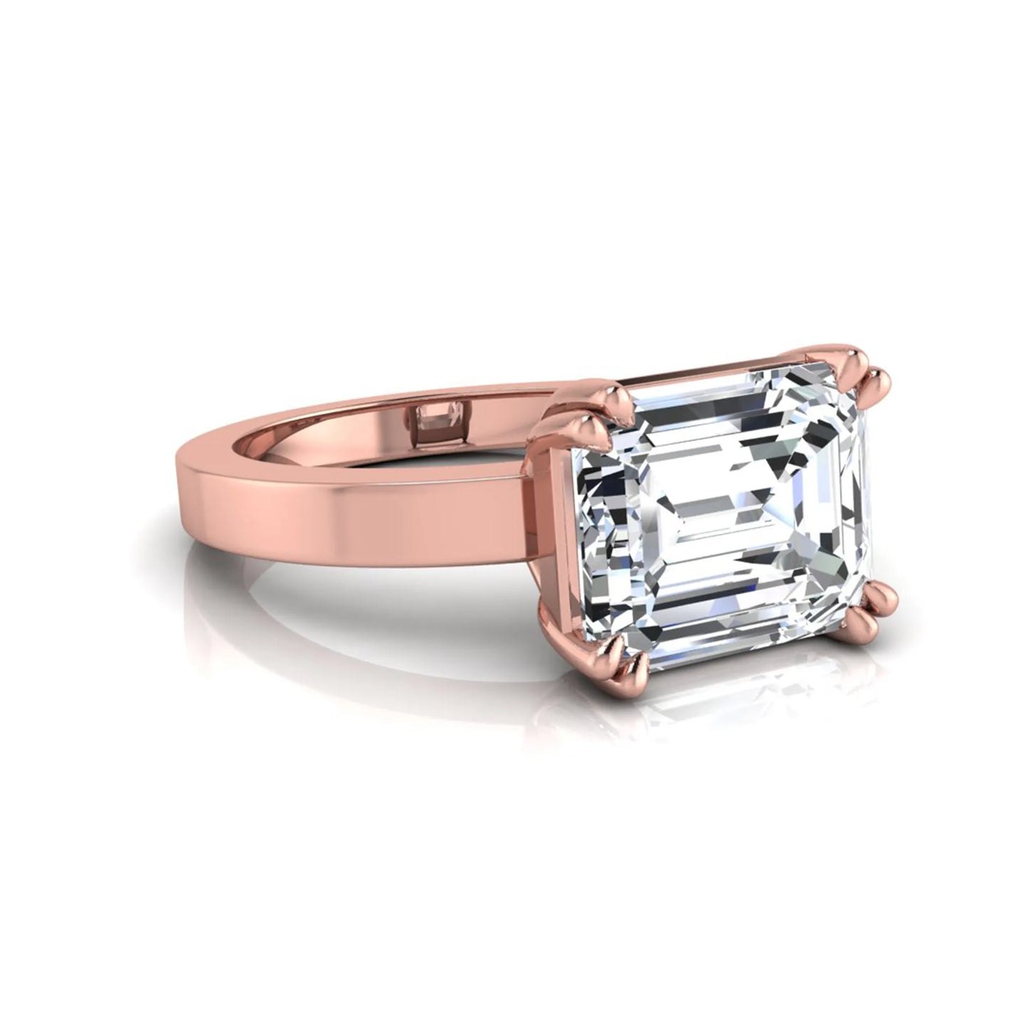 Emerald cut lab grown diamond solitaire engagement ring featuring a 3.79 carat IGI certified center diamond in a double claw prong setting with a rose gold band.