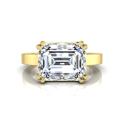Emerald cut lab grown diamond solitaire engagement ring featuring a 3.79 carat IGI certified center diamond in a double claw prong setting with a yellow gold band.