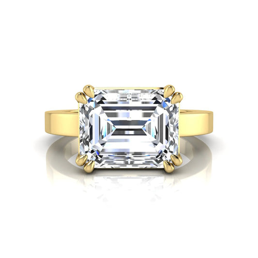 Emerald cut lab grown diamond solitaire engagement ring featuring a 3.79 carat IGI certified center diamond in a double claw prong setting with a yellow gold band.