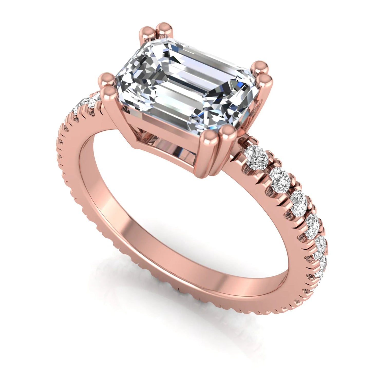 Emerald cut lab grown diamond side stone engagement ring featuring a four-prong setting with round accent diamonds in a rose gold tone design.
