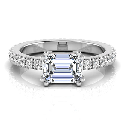 Emerald cut lab grown diamond side stone engagement ring featuring a four-prong setting with round accent diamonds in a white gold tone design.