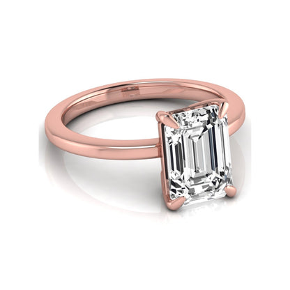 Emerald cut lab grown diamond solitaire engagement ring with a four prong setting in a rose gold tone, featuring an IGI certified 3.01 carat center diamond.