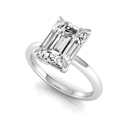 Emerald cut lab grown diamond solitaire engagement ring with a four prong setting in a white gold tone, featuring an IGI certified 3.01 carat center diamond.