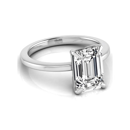Emerald cut lab grown diamond solitaire engagement ring with a four prong setting in a white gold tone, featuring an IGI certified 3.01 carat center diamond.