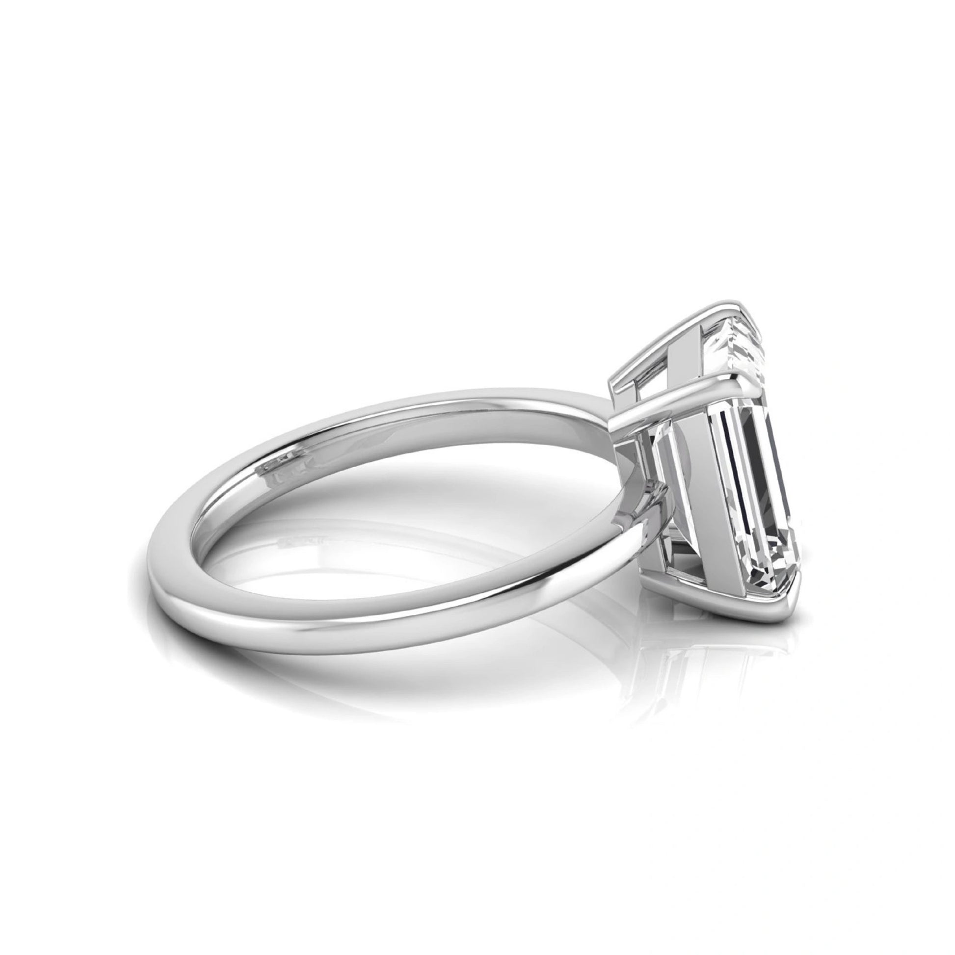 Emerald cut lab grown diamond solitaire engagement ring with a four prong setting in a white gold tone, featuring an IGI certified 3.01 carat center diamond.