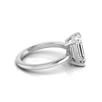Emerald cut lab grown diamond solitaire engagement ring with a four prong setting in a white gold tone, featuring an IGI certified 3.01 carat center diamond.