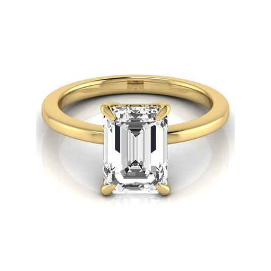 Emerald cut lab grown diamond solitaire engagement ring with a four prong setting in a yellow gold tone, featuring an IGI certified 3.01 carat center diamond.