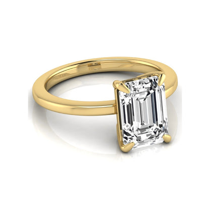 Emerald cut lab grown diamond solitaire engagement ring with a four prong setting in a yellow gold tone, featuring an IGI certified 3.01 carat center diamond.