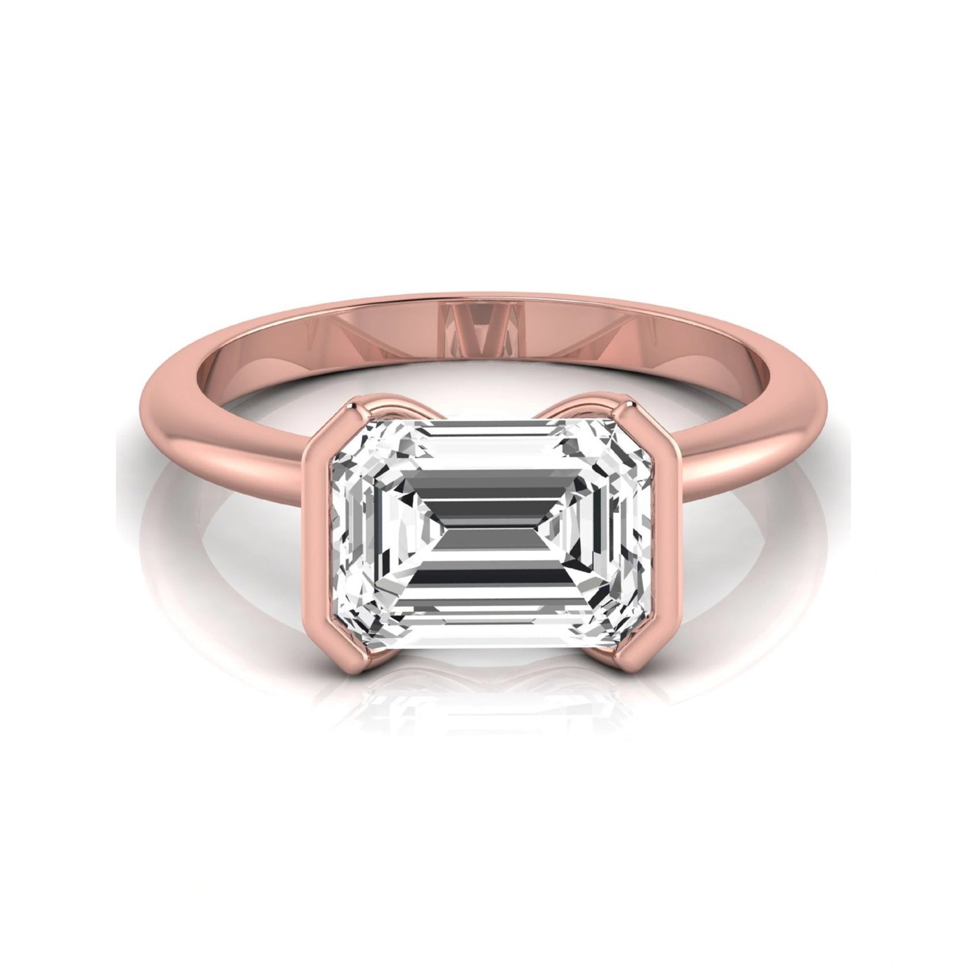 Emerald cut lab grown diamond engagement ring featuring a 5.00 carat center diamond in a modern half bezel solitaire setting with a polished rose gold tone band.