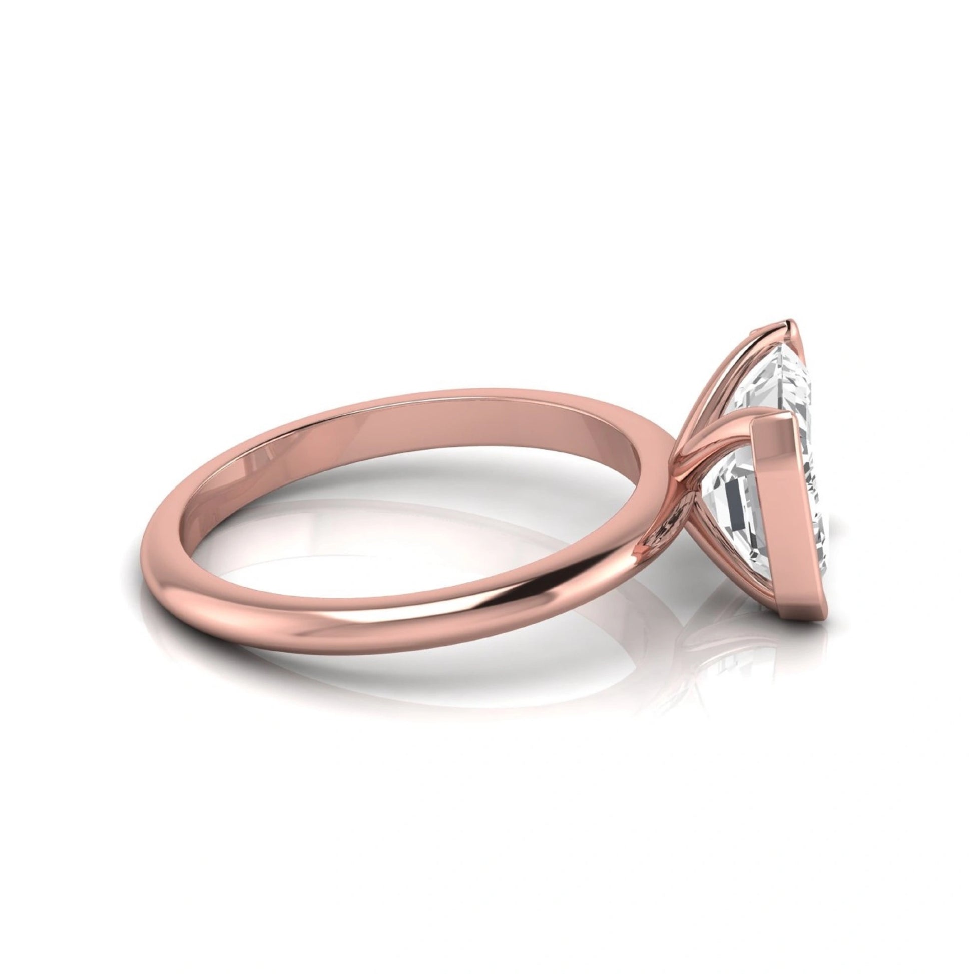 Emerald cut lab grown diamond engagement ring featuring a 5.00 carat center diamond in a modern half bezel solitaire setting with a polished rose gold tone band.