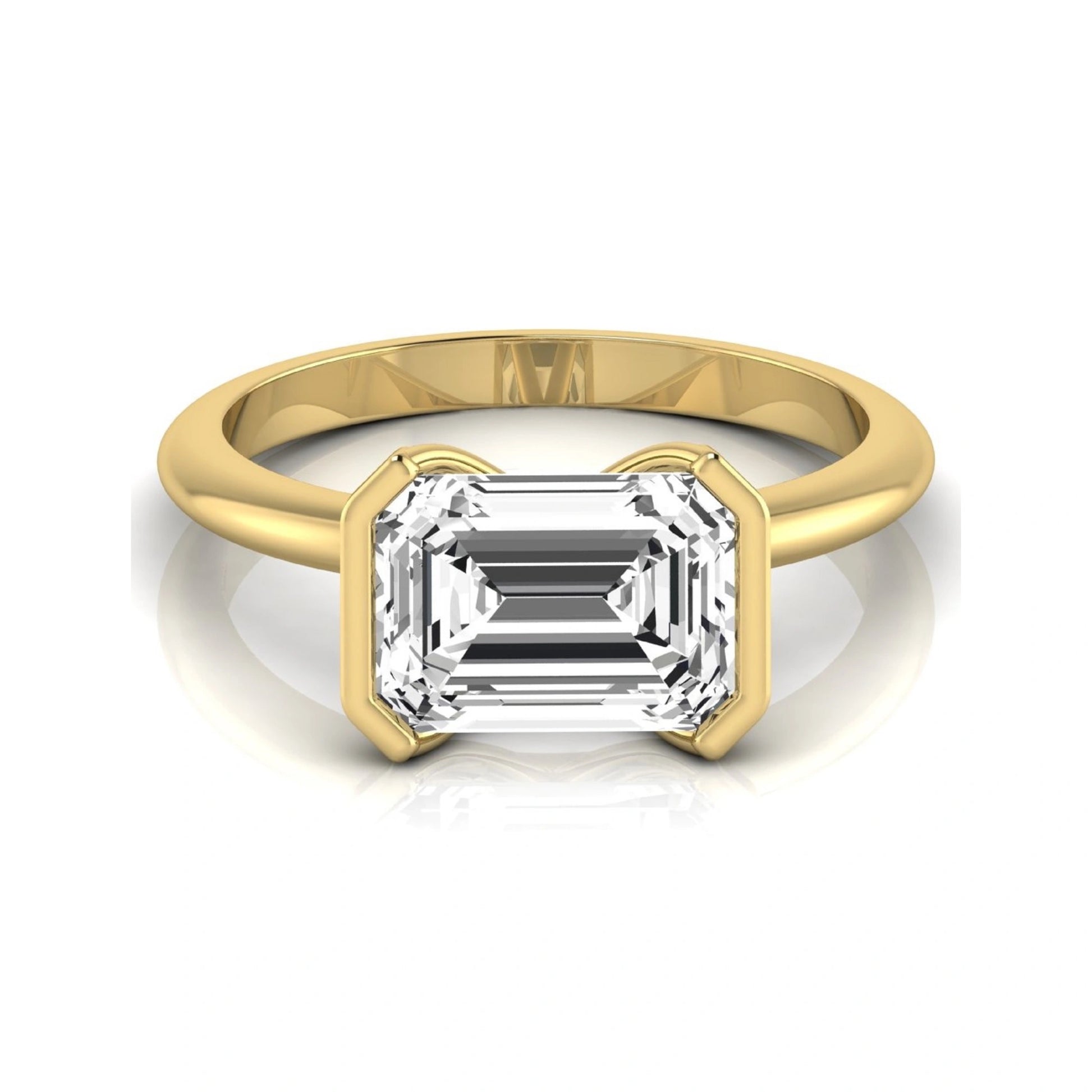 Emerald cut lab grown diamond engagement ring featuring a 5.00 carat center diamond in a modern half bezel solitaire setting with a polished yellow gold tone band.