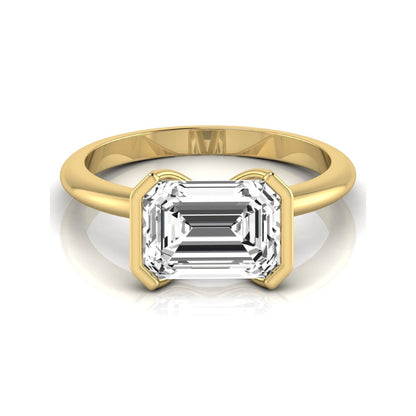 Emerald cut lab grown diamond engagement ring featuring a 5.00 carat center diamond in a modern half bezel solitaire setting with a polished yellow gold tone band.