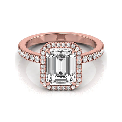 Emerald cut lab grown diamond engagement ring featuring a round diamond halo, pavé accent band, and four-prong setting with a polished rose gold tone band.